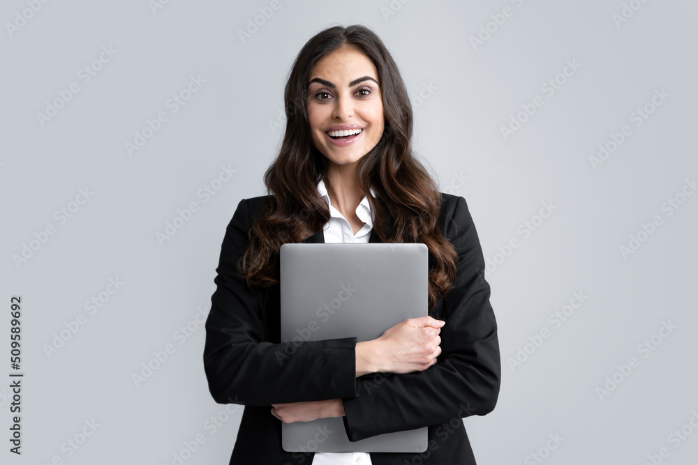 Beautiful smiling business woman over grey background using laptop computer. Beautiful smiling business woman over grey background using laptop computer.