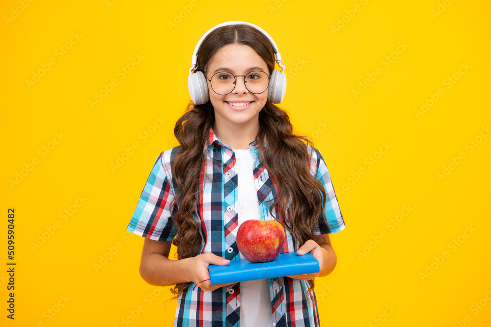 School kids concept. Back to school. Schoolchild, teenage student girl with bagpack hold apple and book. School kids concept. Back to school. Schoolchild, teenage student girl with bagpack hold apple and book.