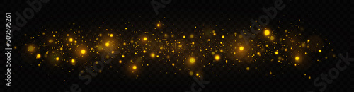 Golden shimmering background with light effect. The dust sparks and golden stars shine with special light on a transparent background. Christmas concept.