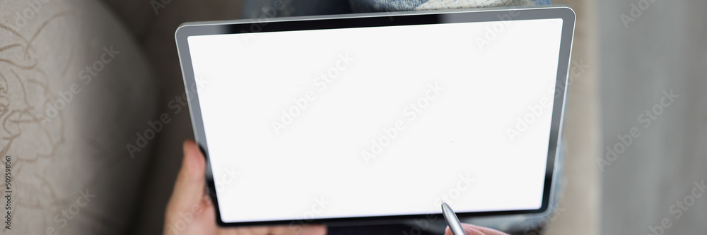 Obraz premium Man surfing internet on modern tablet with stylus