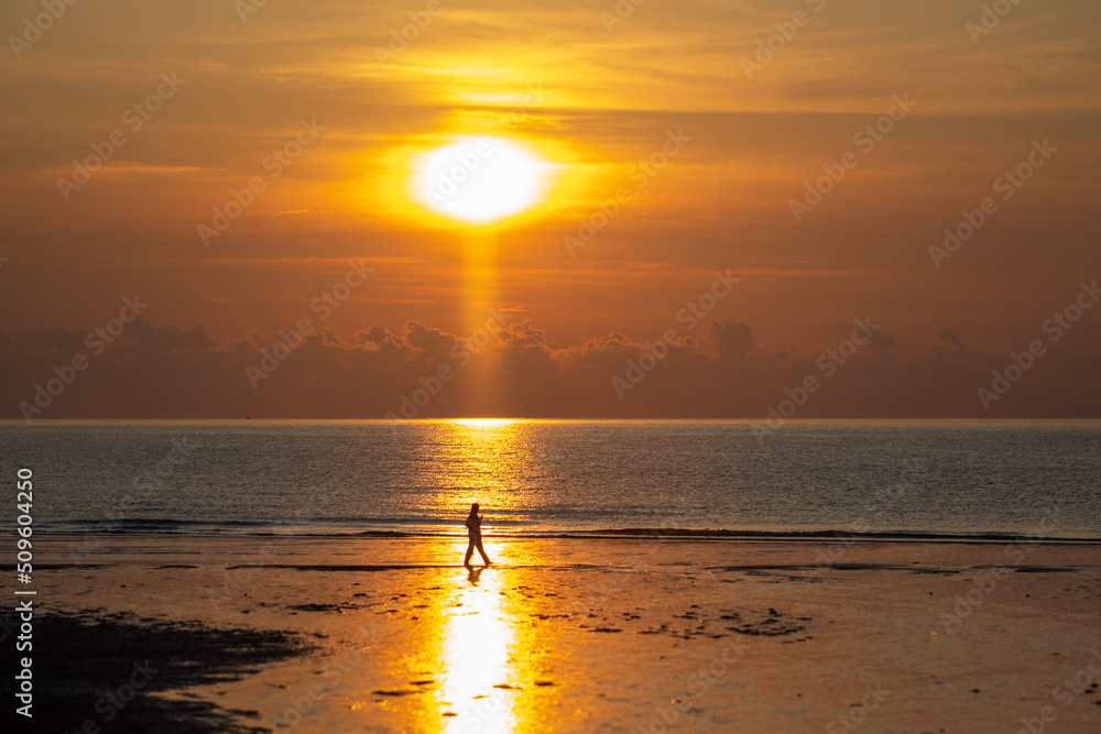 Fototapeta premium Silhouette of walking man against sunrise..