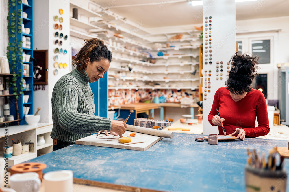 Fototapeta premium Concentrated Women in Pottery Class