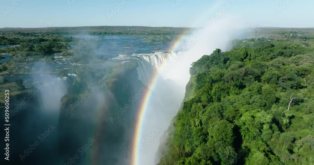 Spectacular high aerial fly over view looking through a rainbow at the scenic Victoria falls. Unesco world heritage site Spectacular high aerial fly over view looking through a rainbow at the scenic Victoria falls. Unesco world heritage site