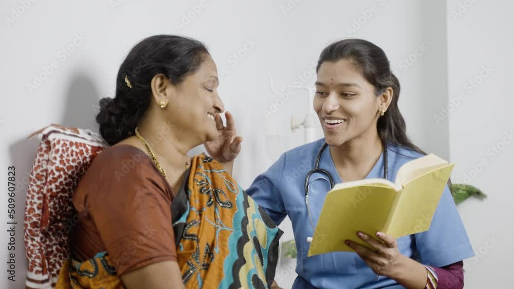 Nurse and sick women laughing by reading story from book at home - concept of relaxation, happiness and caring. Nurse and sick women laughing by reading story from book at home - concept of relaxation, happiness and caring.