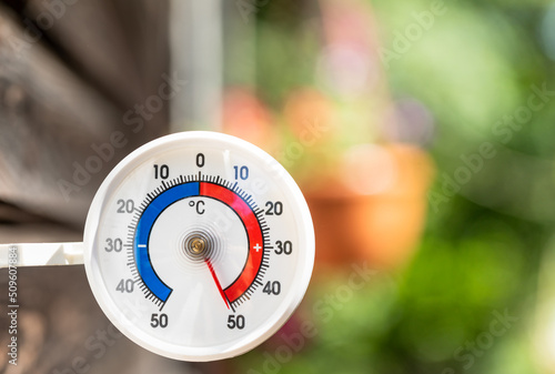 Outdoor thermometer with celsius scale shows extreme hot temperature 50 degree - summer heatwave concept photo