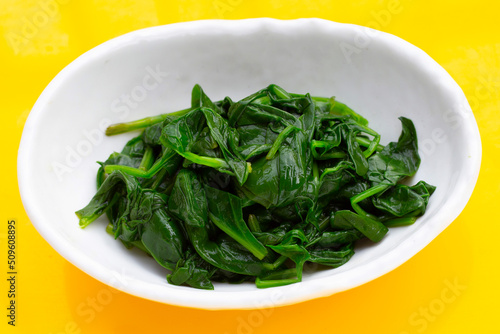 Boiled spinach in white bowl