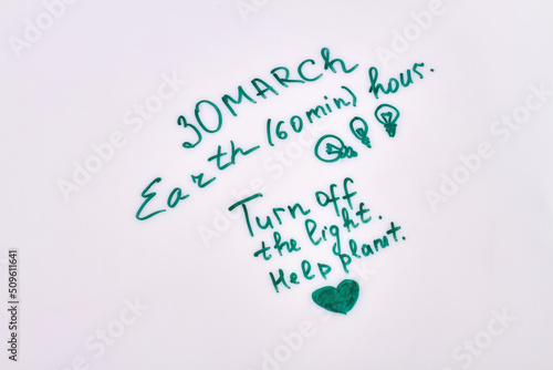 30 march earth hour. Turn off the light save plannet. Handwriting on white background. photo