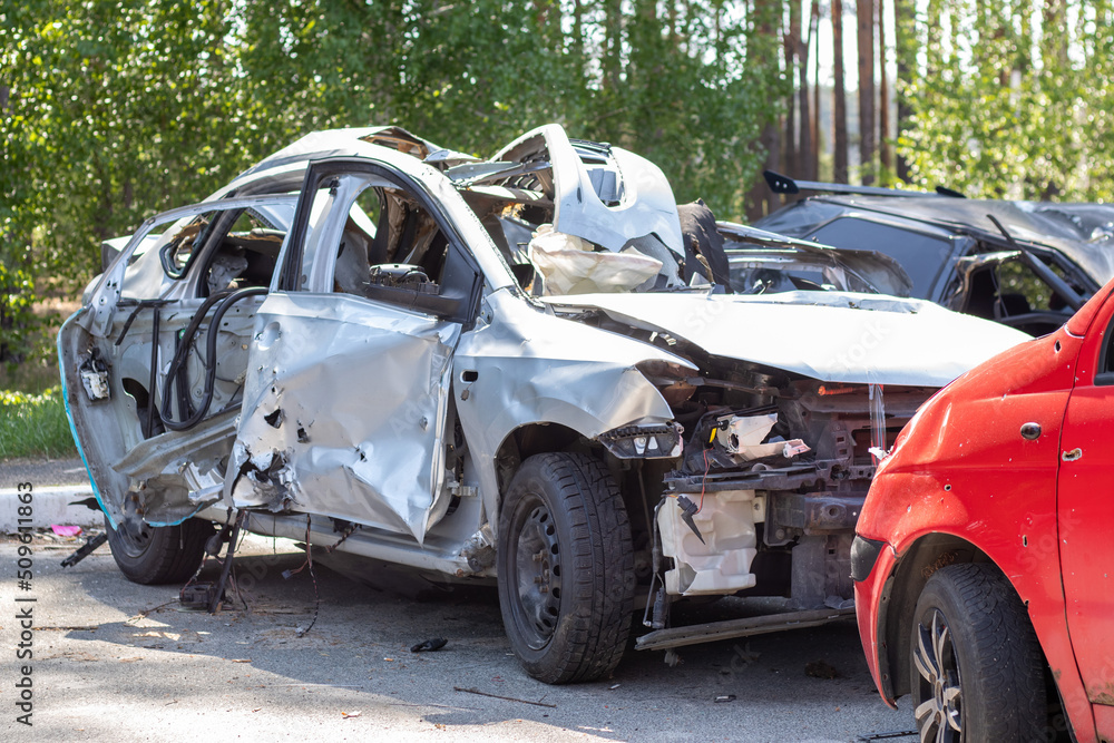 Many broken cars after a traffic accident in the parking lot of a restoration service station on the street. Car body damage workshop outdoors. Sale of insurance emergency vehicles at auction. Many broken cars after a traffic accident in the parking lot of a restoration service station on the street. Car body damage workshop outdoors. Sale of insurance emergency vehicles at auction.