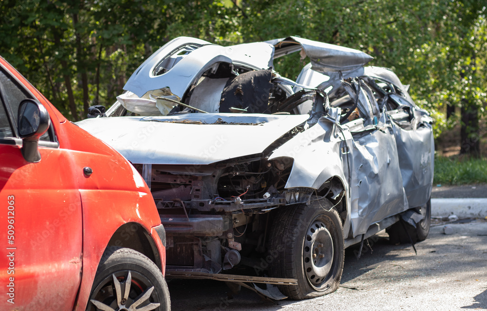 Many broken cars after a traffic accident in the parking lot of a restoration service station on the street. Car body damage workshop outdoors. Sale of insurance emergency vehicles at auction. Many broken cars after a traffic accident in the parking lot of a restoration service station on the street. Car body damage workshop outdoors. Sale of insurance emergency vehicles at auction.