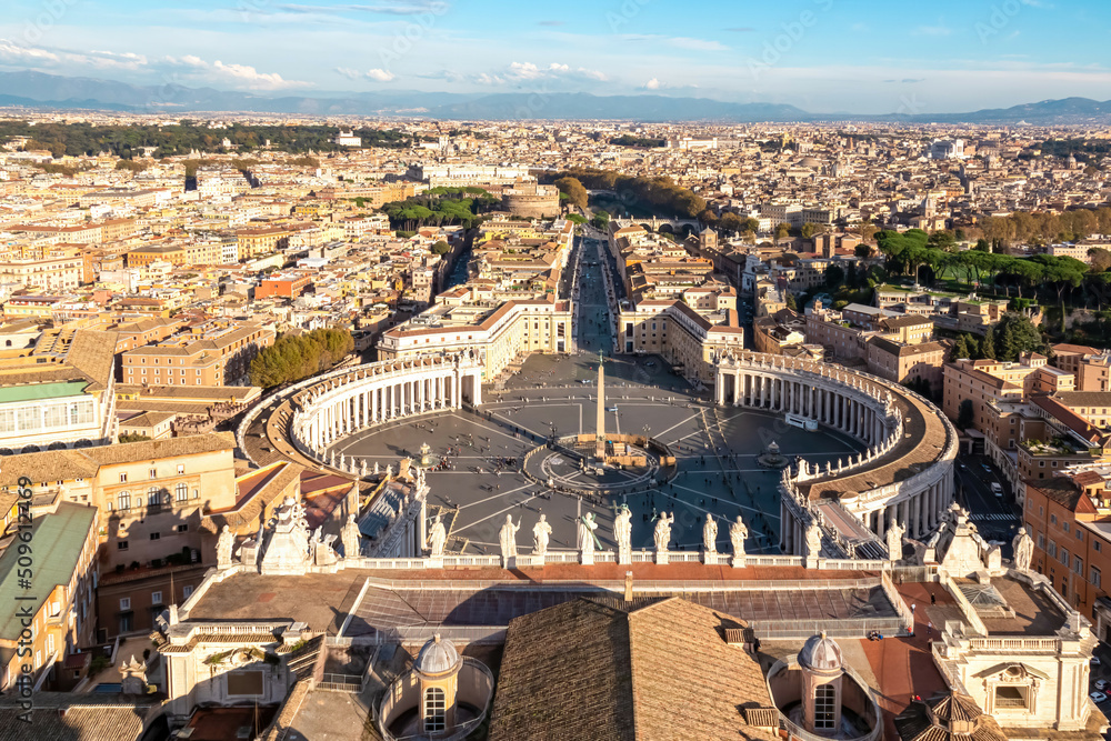 Panoramic scenic high angle aerial view on St Peters Square from top of Peters Basilica in Vatican City, Rome, Lazio, Europe, EU. Catholic statues overlooking city skyline and obelisk in center