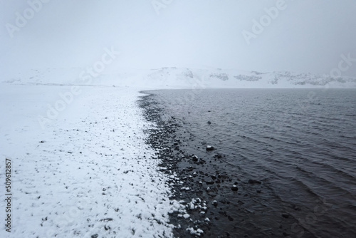 Black and white Reynisfjara volcanic beach with basalt sculpture columns raise up from the sea. Iceland, Europe. photo