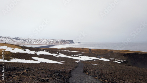 View from Dyrholaey lighthouse in Iceland looking out over the black sand beach. photo