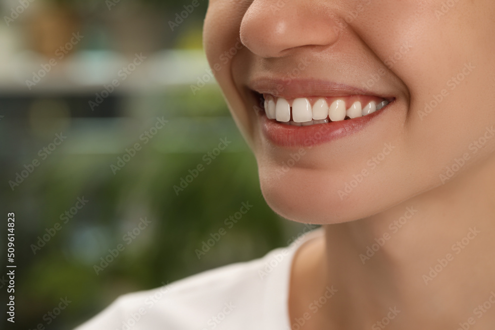 Woman with diastema between upper front teeth on blurred background, closeup Woman with diastema between upper front teeth on blurred background, closeup
