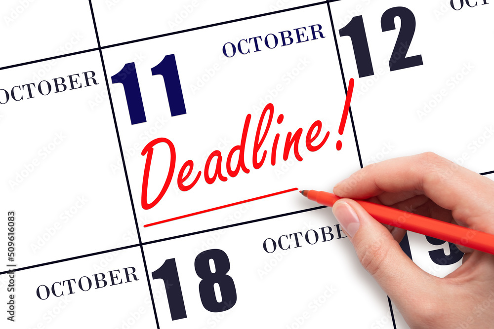 Hand drawing red line and writing the text Deadline on calendar date October 11. Deadline word written on calendar Hand drawing red line and writing the text Deadline on calendar date October 11. Deadline word written on calendar