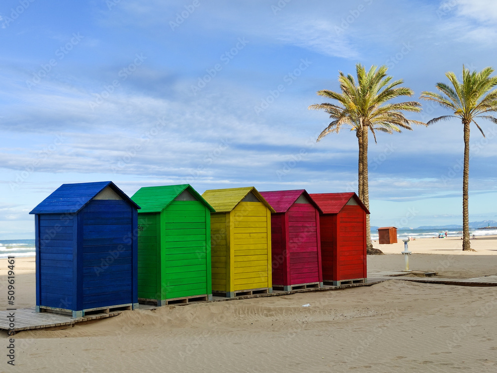 colorful dressers on the beach and palm trees in the background colorful dressers on the beach and palm trees in the background