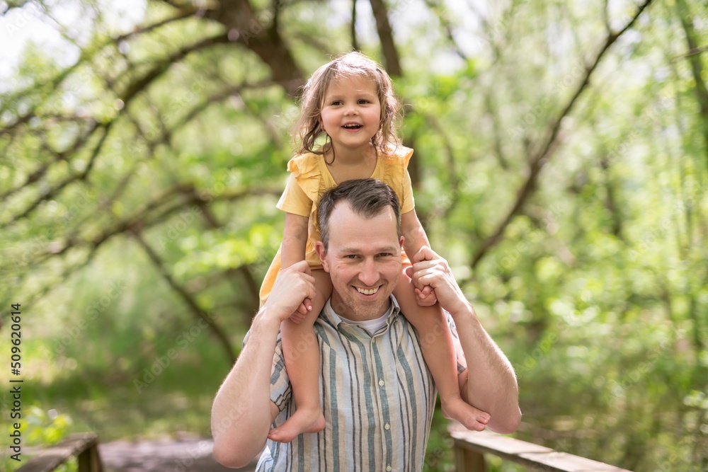 Fototapeta premium Father with his daughter having fun outside in forest