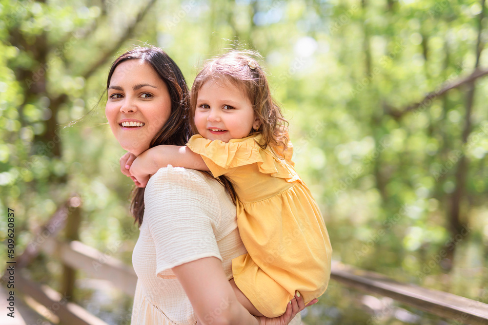 mother with his daughter having fun outside in forest mother with his daughter having fun outside in forest