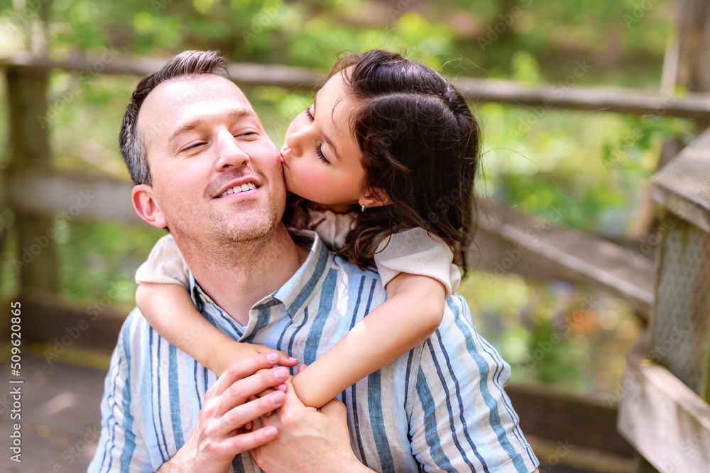 Obraz premium Father with his daughter having fun outside in forest