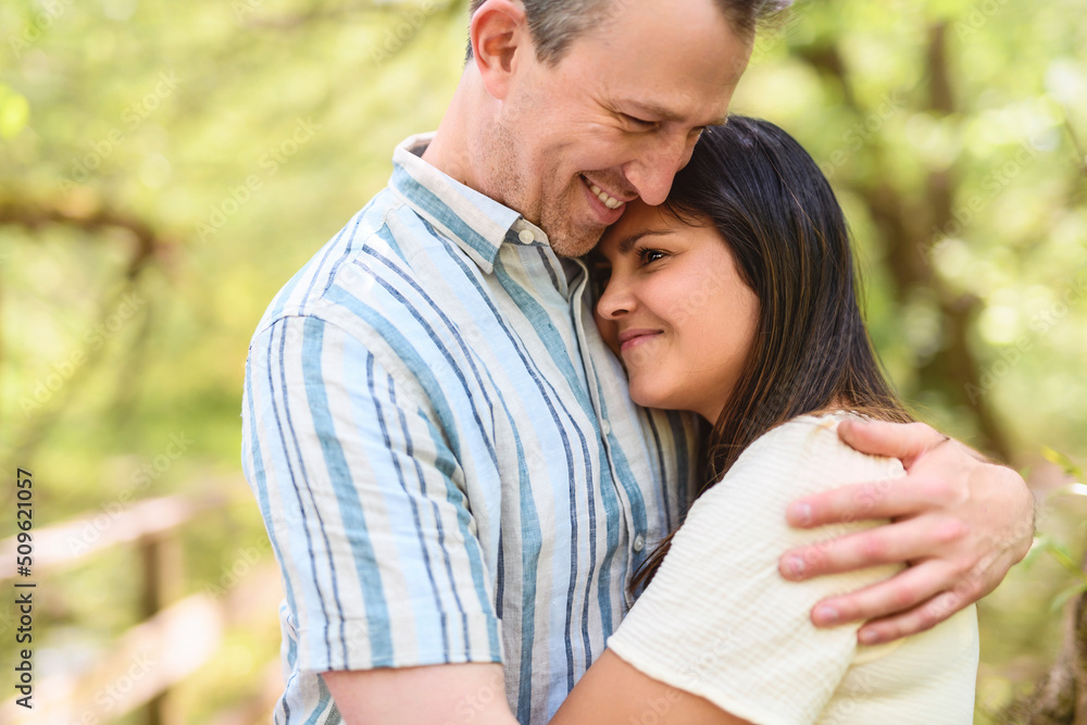 Young Caucasian couple outside in the forest background Young Caucasian couple outside in the forest background
