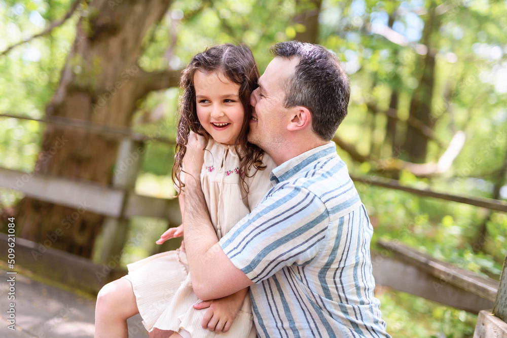 Father with his daughter having fun outside in forest Father with his daughter having fun outside in forest