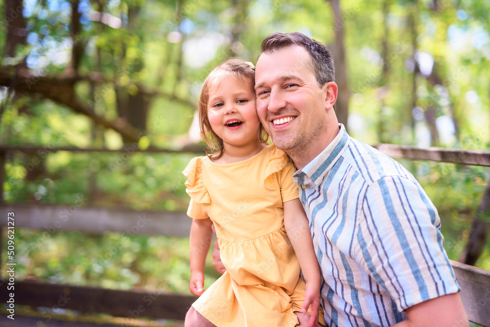 Fototapeta premium Father with his daughter having fun outside in forest