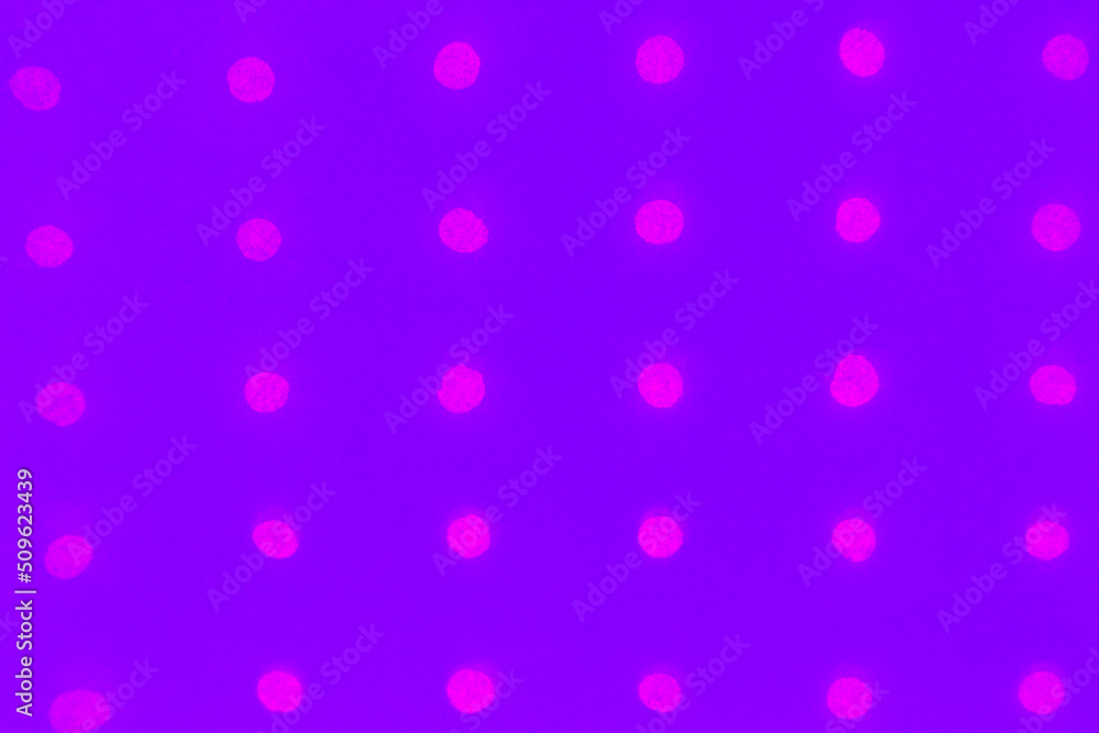 Abstract purple paper background with holes arranged in a row and glowing with neon color Abstract purple paper background with holes arranged in a row and glowing with neon color