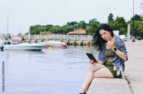 Portrait of young happy business woman relaxing, working at beach at Adriatic seaside. Using laptop. Technology. Video call. Summer vacation. 