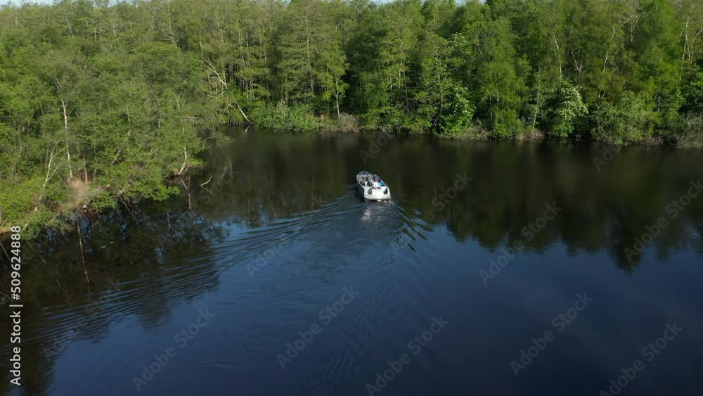 Cruising Across Pristine Lake With Reflection In Ossenzijl, Friesland, Netherlands. Aerial Drone Shot Cruising Across Pristine Lake With Reflection In Ossenzijl, Friesland, Netherlands. Aerial Drone Shot