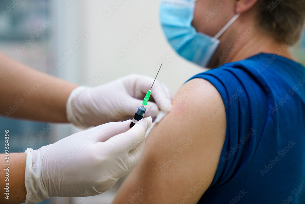 Vaccination against monkeypox. Man getting vaccinated with adult immunization schedule. Seasonal virus protection, covid vaccine. Outbreak disease prevention. Medical nurse in hold injection syringe Vaccination against monkeypox. Man getting vaccinated with adult immunization schedule. Seasonal virus protection, covid vaccine. Outbreak disease prevention. Medical nurse in hold injection syringe