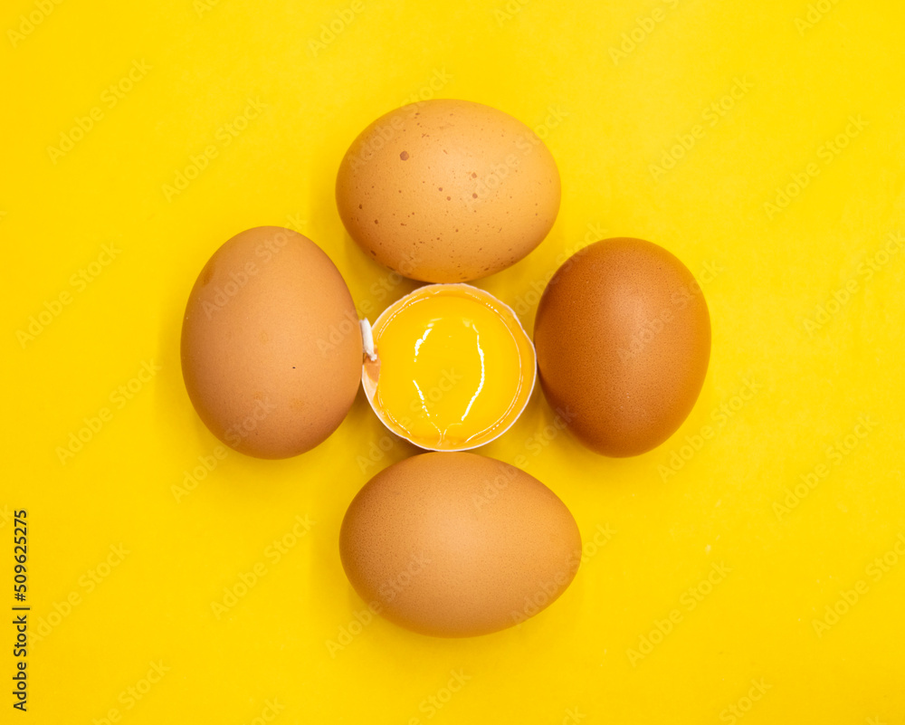 whole eggs and broken isolated on yellow background. whole eggs and broken isolated on yellow background.