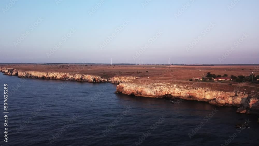 Drone top down aerial view of waves splash against rocky seashore, background. Flight over high cliffs of sea coast. Drone top down aerial view of waves splash against rocky seashore, background. Flight over high cliffs of sea coast.