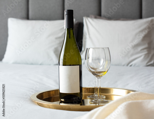 glass of wine on the bed in apartment