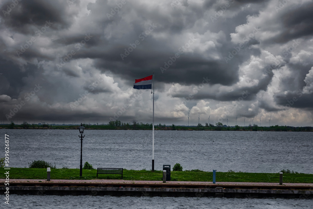 Thick rain clouds over the Dutch North Sea at the port of Volendam