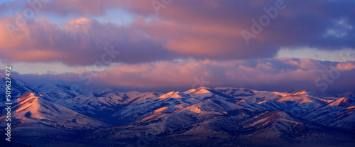 Sunrise or Sunset Sunlight on Snowy Mountains Pink Light © Lane Erickson