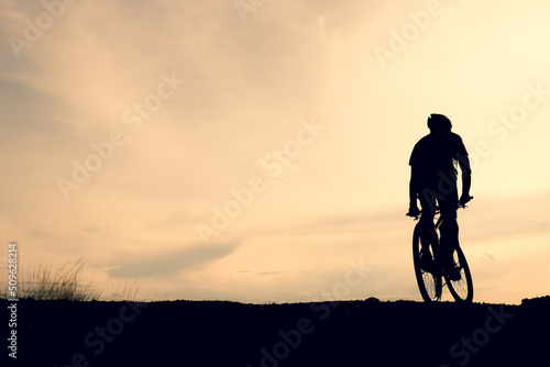 Silhouettes of mountain bikes and cyclists in the evening happily. Travel and fitness concept © STOCK PHOTO 4 U