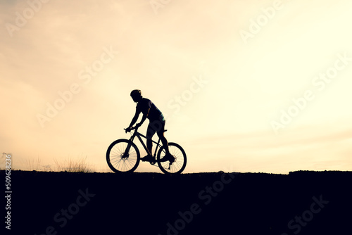 Silhouettes of mountain bikes and cyclists in the evening happily. Travel and fitness concept