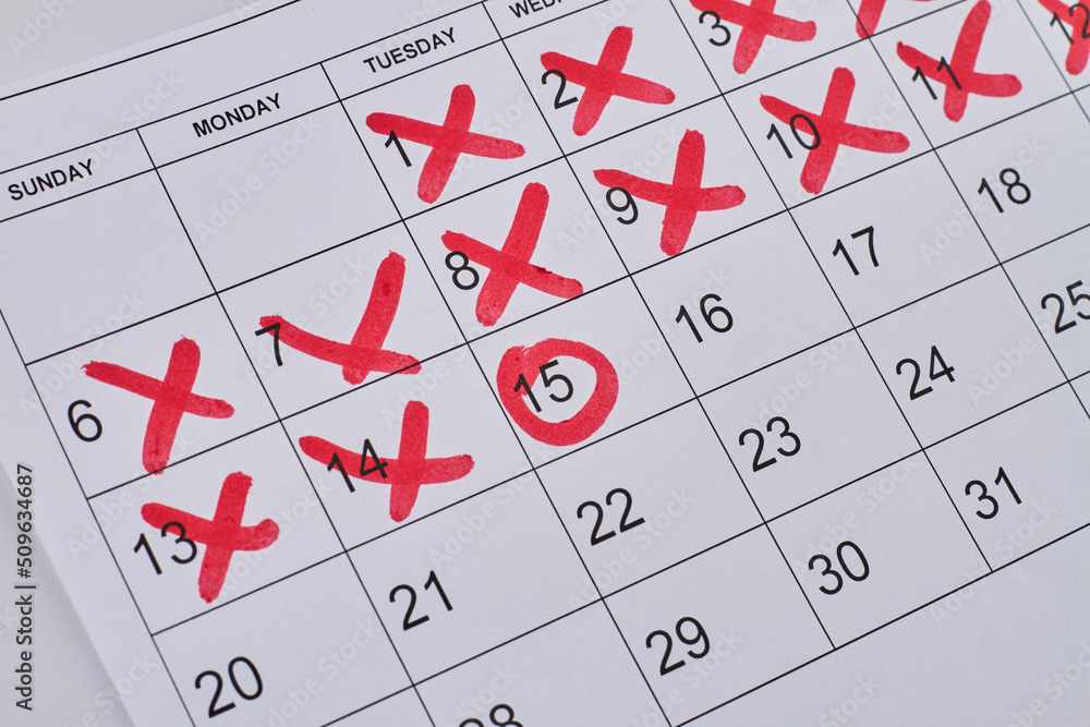 Paper calendar with red crosses and circle closeup-up. Business appointment concept. Paper calendar with red crosses and circle closeup-up. Business appointment concept.