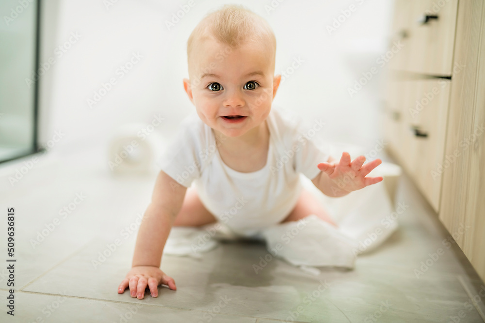 Adorable baby boy playing with toilet paper Adorable baby boy playing with toilet paper