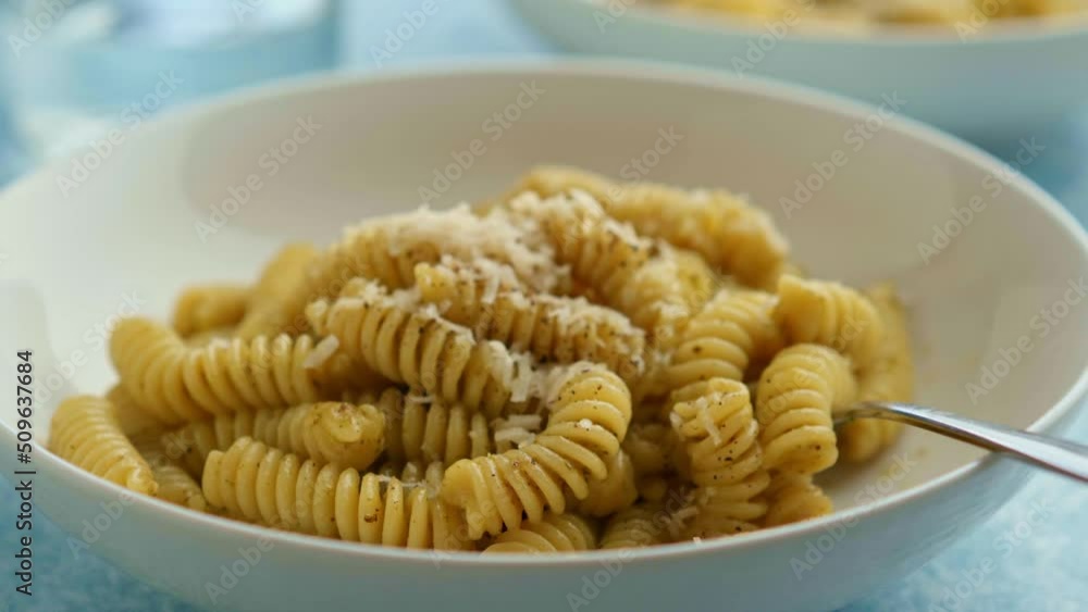 Plate of pasta with pesto Genovese, with fresh basil, olive oil, garlic and pine nuts Plate of pasta with pesto Genovese, with fresh basil, olive oil, garlic and pine nuts