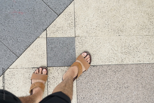 highway paving design with pedestrian feet wearing sandals