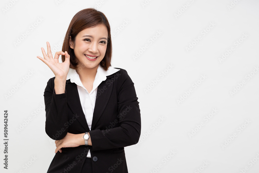 Asian businesswoman smiling and showing OK sign isolated on white background Asian businesswoman smiling and showing OK sign isolated on white background
