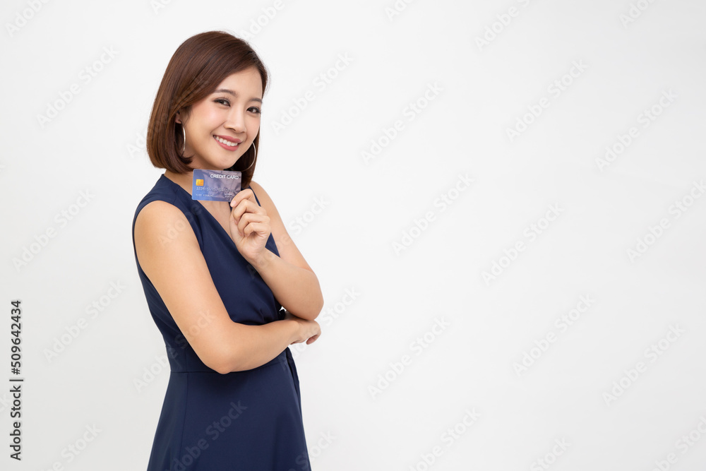 Happy young Asian woman smiling and showing credit card for paying online business isolated on white background Happy young Asian woman smiling and showing credit card for paying online business isolated on white background