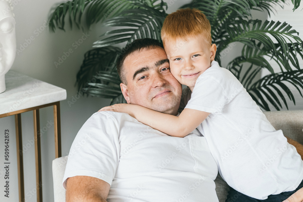 Fototapeta premium Father and son at home on the couch. 