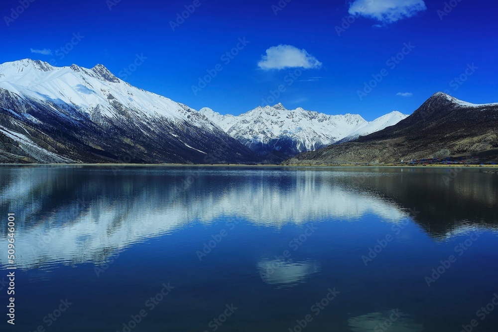 snow mountain reflex on the river with blue sky