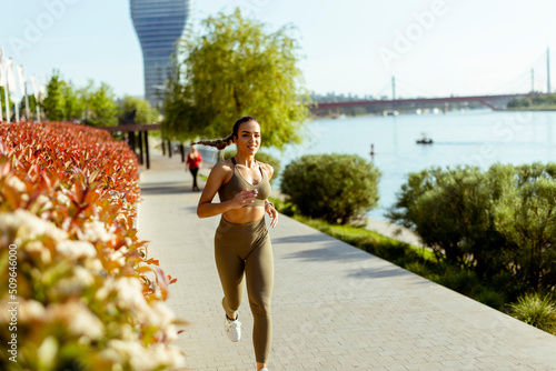 Young woman taking running ...