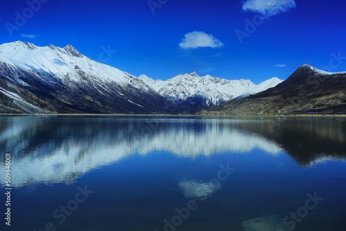 snow mountain reflex on the river with blue sky