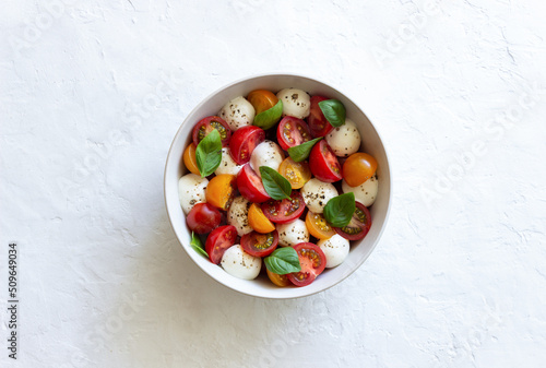 Salad with mozzarella, tomatoes and basil. Healthy eating. Vegetarian food.