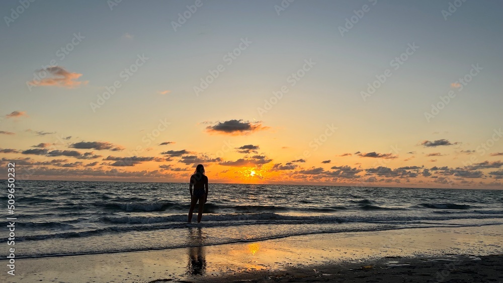 Silhouette of a Man Watching the Sunset over the Ocean