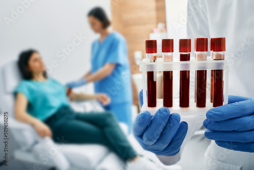 Blood test for allergies. Nurse taking blood for allergen testing by collecting blood in test tubes at laboratory photo