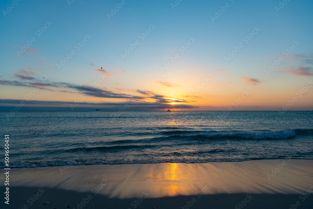 calm sunset with sea water on the summer beach
